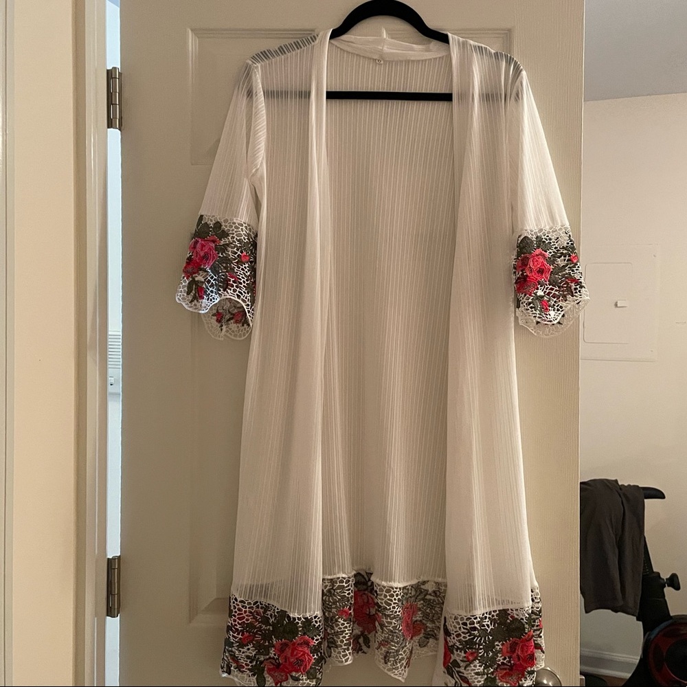 White robe with pink and green lace detail